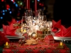 gold and red christmas table decoration with dim light candle